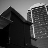 A black and white photo of buildings against the sky
