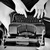 Auto-generated description: A person with a sun tattoo on their forearm is typing on an Underwood typewriter.