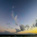 Auto-generated description: A serene ocean view at sunset features a wide sky with scattered clouds and a gently lit horizon.