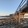 Joining Bare Island to the mainland at La Perouse, Sydney, a wooden bridge extends over a rocky shoreline beside a calm ocean at sunset.