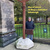 Yousef Qandeel stands beside a large key sculpture — The Key of Return — on a pedestal outside St. Mary's Cathedral in Edinburgh.