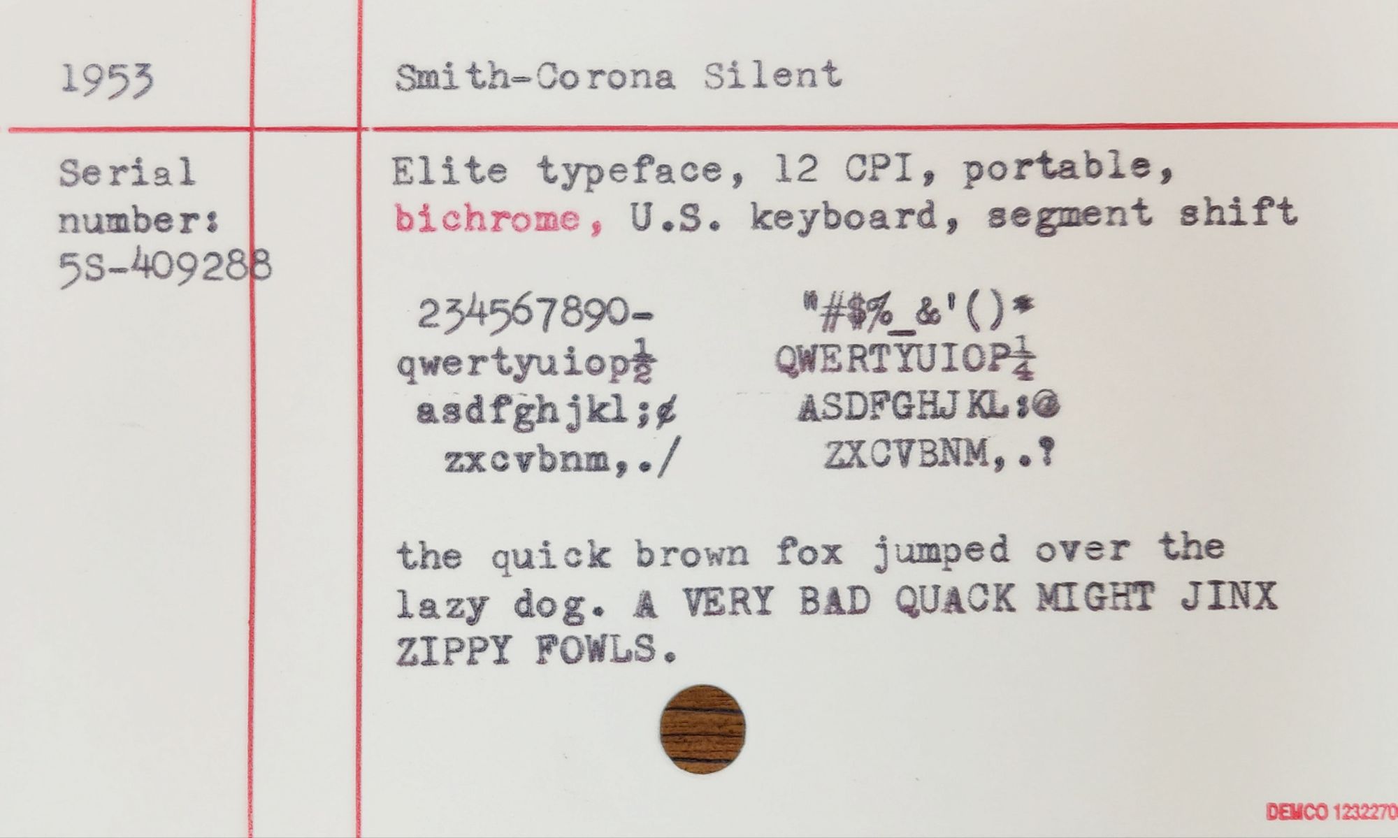 Cream index card with red lines that contains a typing sample that reads: 1953 Smith-Corona Silent
Serial number: 5S-409288 
Elite typeface, 12 CPI, portable, bichrome, U.S. keyboard, segment shift 
234567890- qwertyuiop asdfghjkl; zxcvbnm,./ *#$%&'()* QWERTYUIOP ASDFGHJKLO ZXCVBNM,.? the quick brown fox jumped over the lazy dog. A VERY BAD QUACK MIGHT JINX ZIPPY FOWLS.