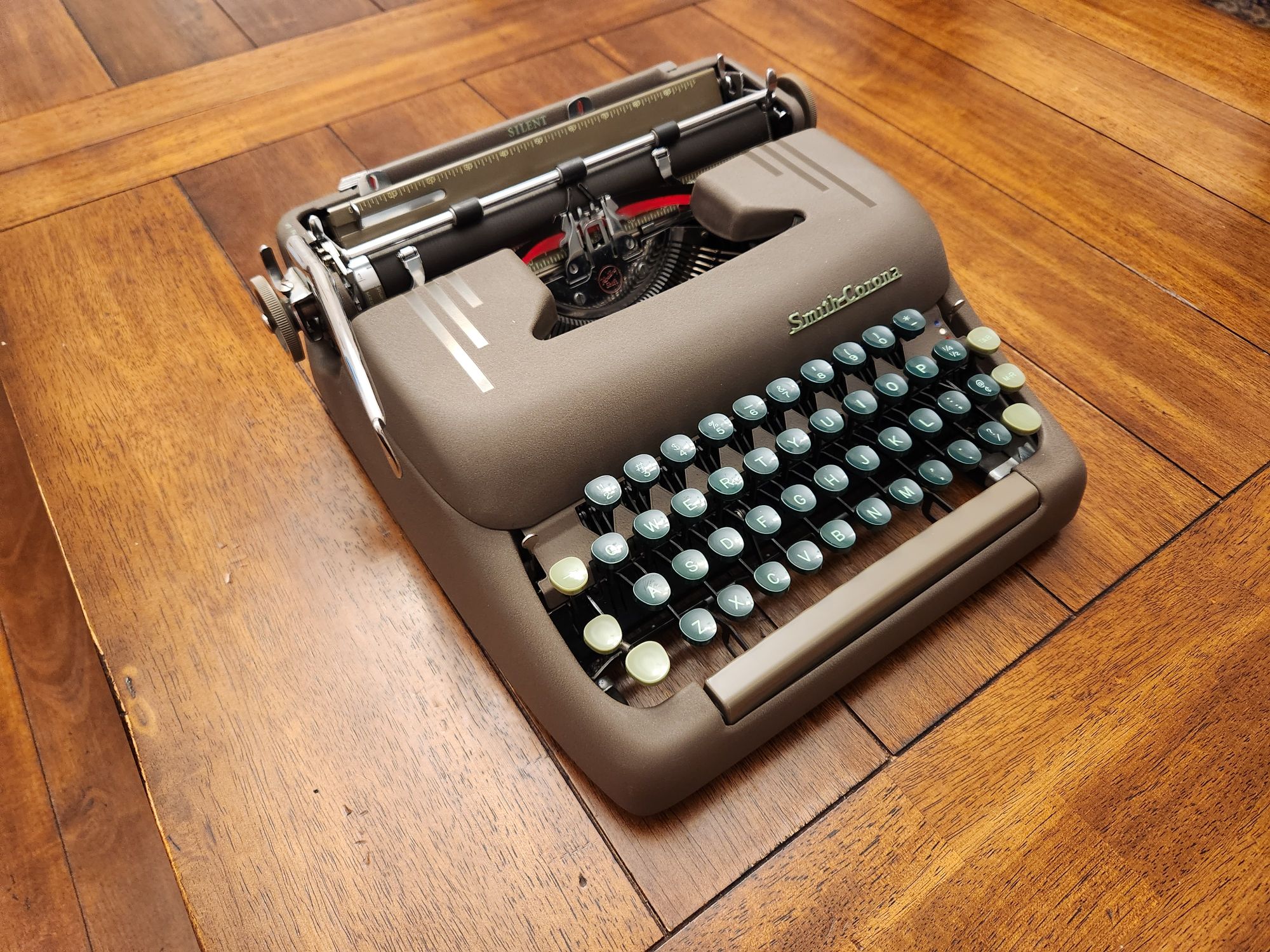 Angle on a brown crinkle painted typewriter with green keys.