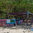 Fay's Bar on Princess Margaret Beach with hand-painted signs and rum punch board under almond trees