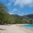 Princess Margaret Beach wide view showing white sand, turquoise water and wooded hillside, Bequia