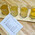 A flight of four meads and ciders on a wooden paddle next to a menu card listing the selected flavours