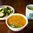 A dish of sesame cucumbers, hot and sour soup, and oolong tea. 