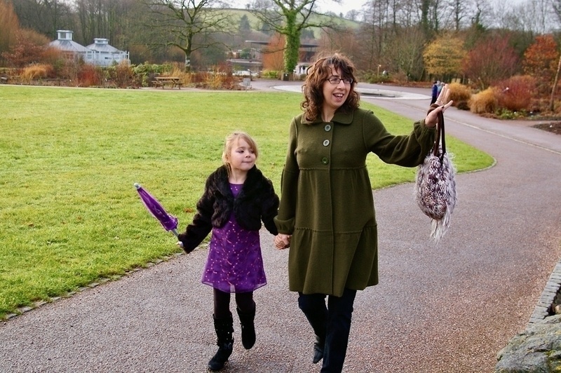Mother and daughter in nice clothes, walking and waving