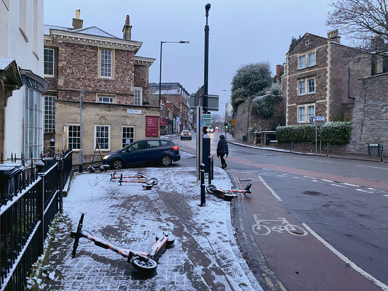 City street scene with a light covering of snow