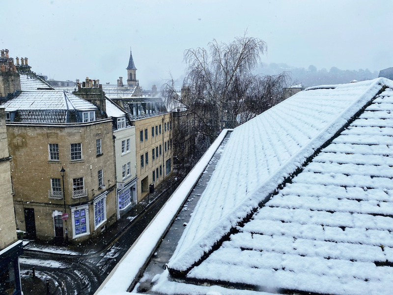 View from high building across snow covered rooftop