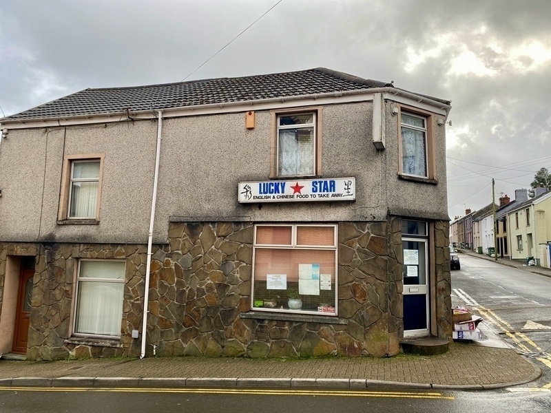 Exterior of small Chinese takeaway restaurant in a converted corner terraced house, called Lucky Star