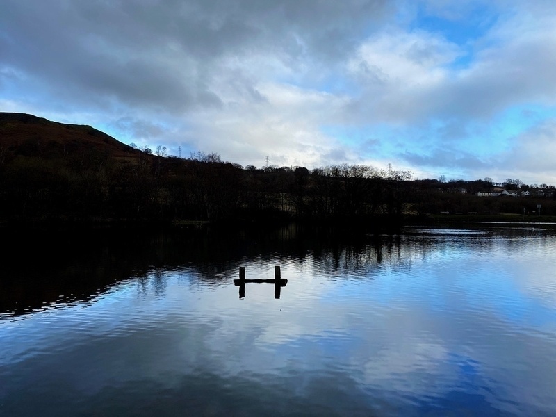Clouds and blue sky reflected on the surface of a lake