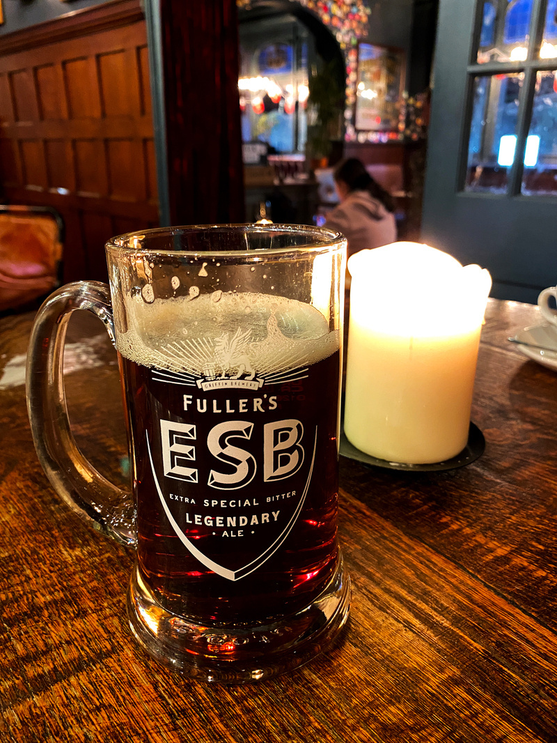  Candlelit pint of beer on a pub table
