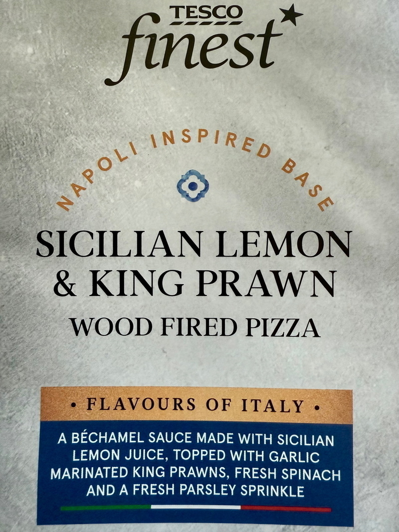Auto-generated description: A Tesco Finest Sicilian Lemon & King Prawn wood-fired pizza package highlights a Napoli-inspired base with a béchamel sauce, lemon juice, garlic-marinated king prawns, fresh spinach, and parsley.