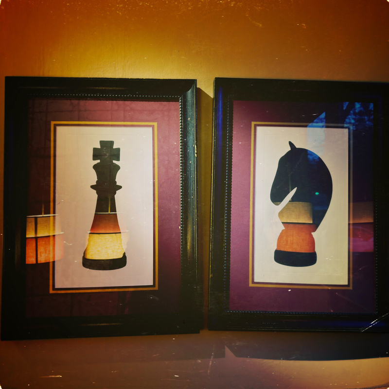 Two framed chess piece artworks are displayed side by side, featuring a king and a knight.